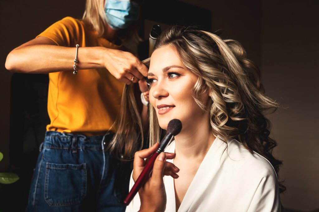 Hairdresser make hairstyle for pretty woman at morning. Make-up artist make wedding makeup