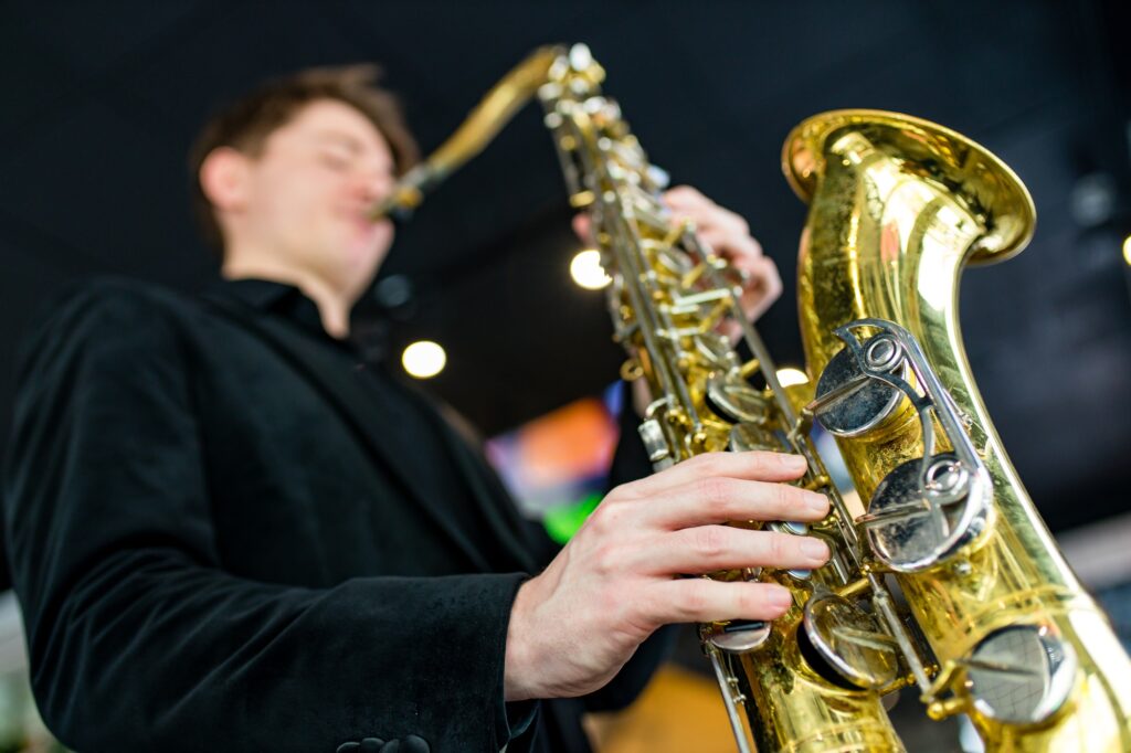 Male jazz musician playing a saxophone in a restaurant
